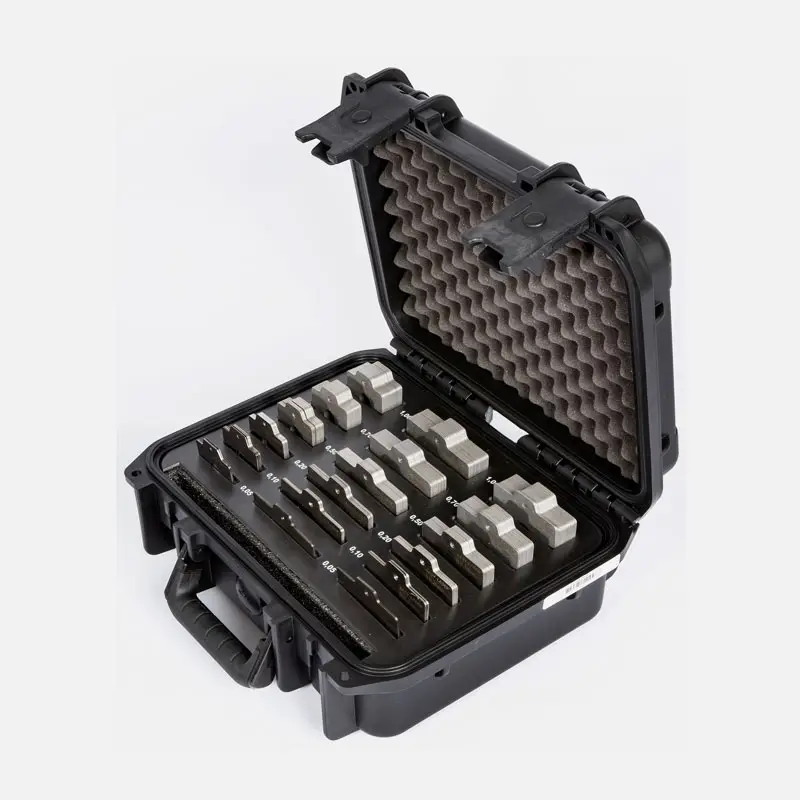 Black hard-shell case with foam padding holding organized metal gauge blocks.
