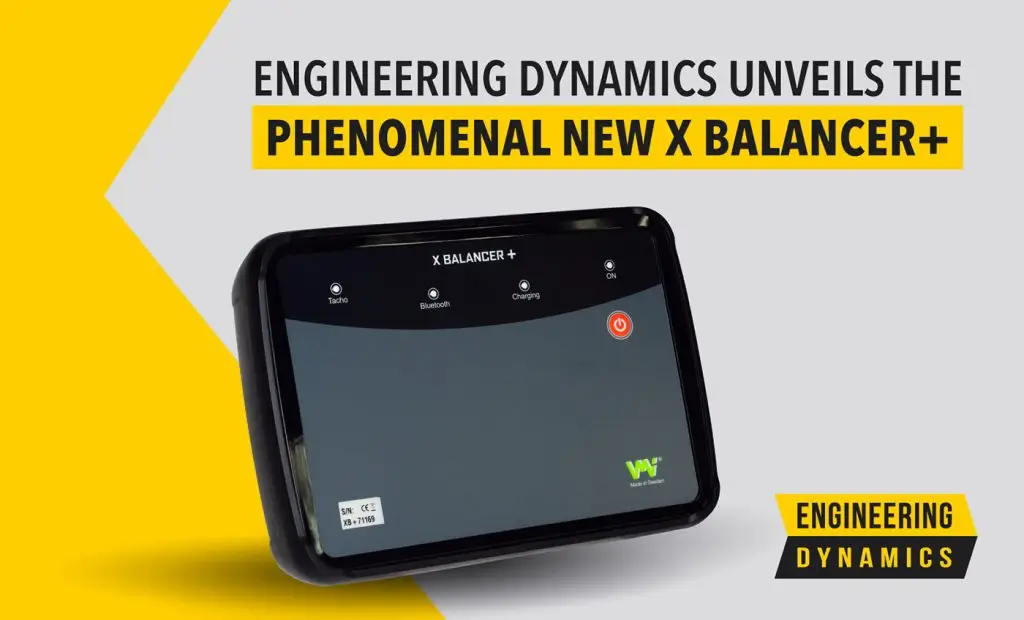 Black electronic device labeled X Balancer+ on yellow-gray background with text.