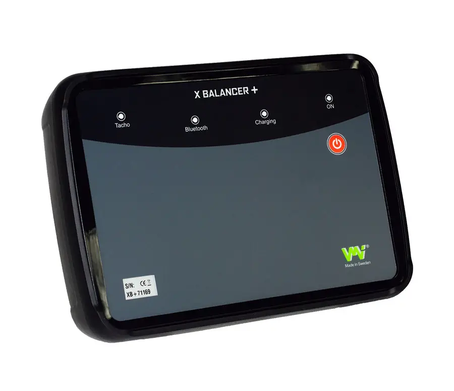 Rectangular electronic device labeled X BALANCER + with indicator lights and green logo.