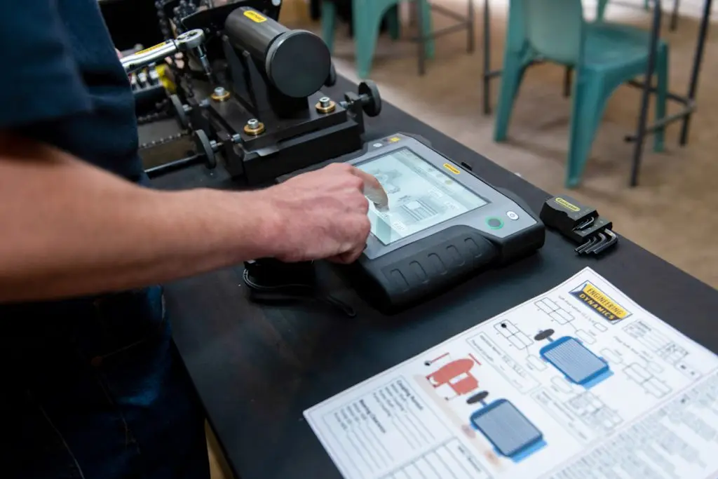 “Technician using touchscreen with engineering schematics”