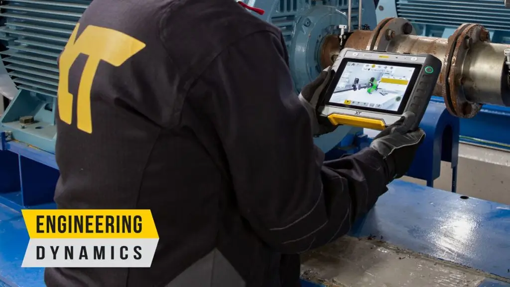 “Technician using XT tablet for machinery alignment in industrial setting”
